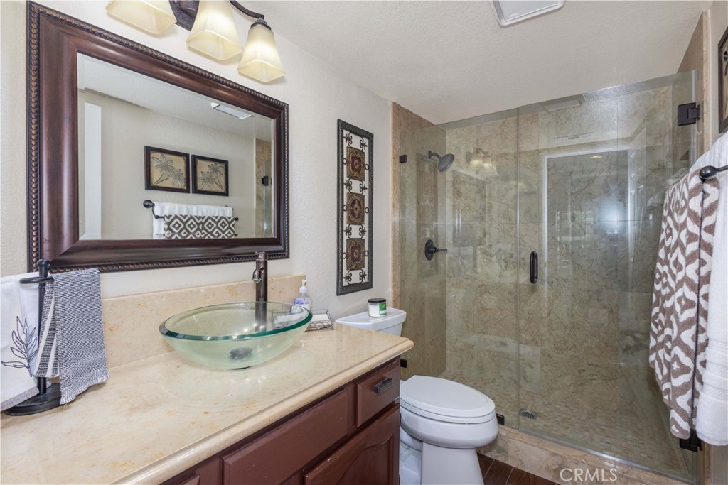 31858 Valone Court Temecula, CA 92591 - Photo 12 of 45 a bathroom with a granite countertop sink toilet and shower