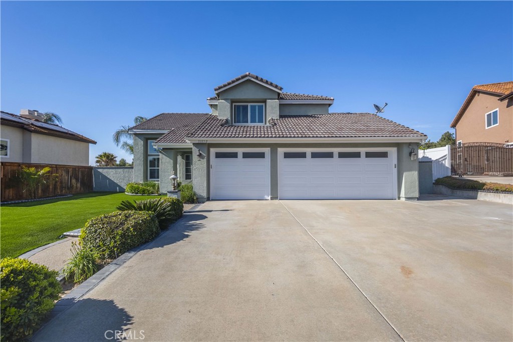 31858 Valone Court Temecula, CA 92591 - Photo 2 of 45 a front view of a house with a garden and yard