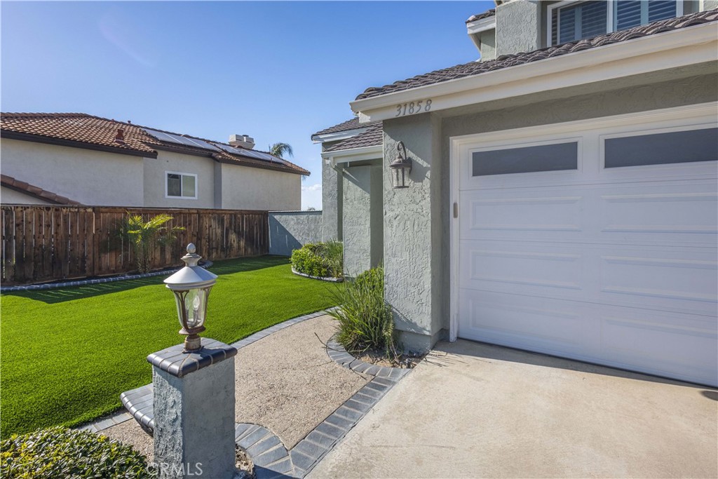31858 Valone Court Temecula, CA 92591 - Photo 4 of 45 a front view of a house with garden and a tree