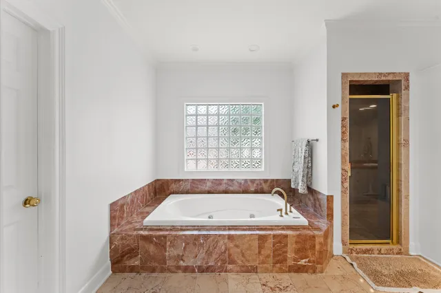 a view of bathroom with bathtub and window