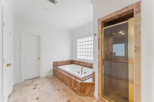 a bathroom with a tub and shower