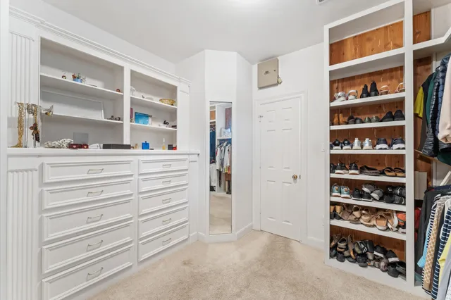 a view of bedroom with cabinets and closet