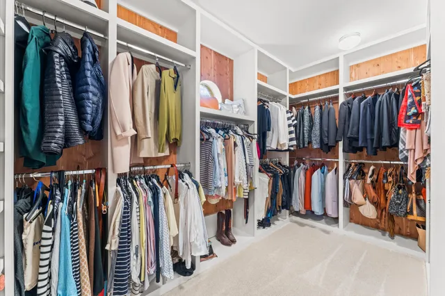 a view of walk in closet with clothes