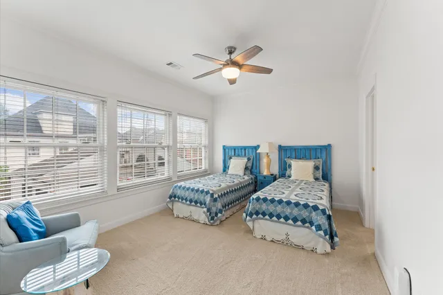 a bedroom with two beds and a couch