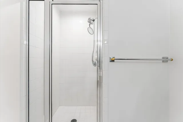 a view of a dining room with furniture and a chandelier fan