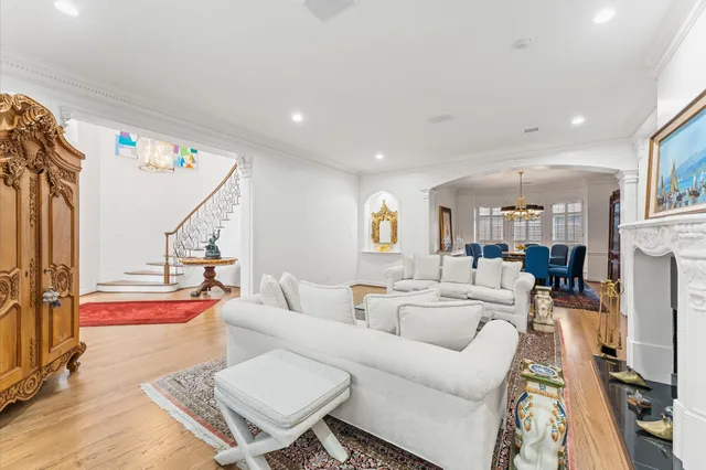 a living room with furniture a flat screen tv and a table