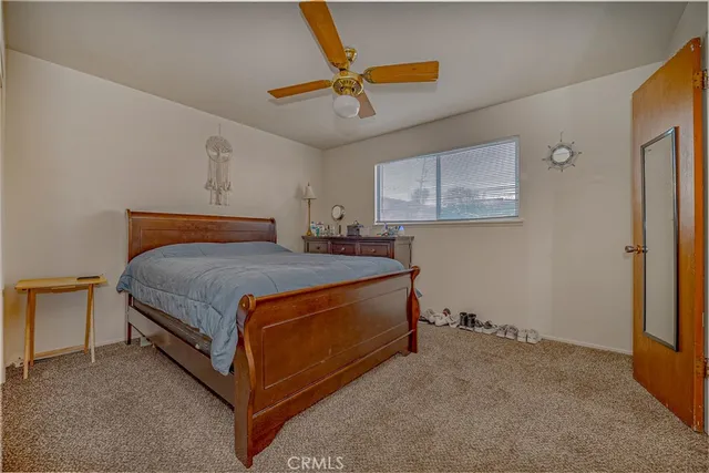 a blue bed sitting in a room next to a window