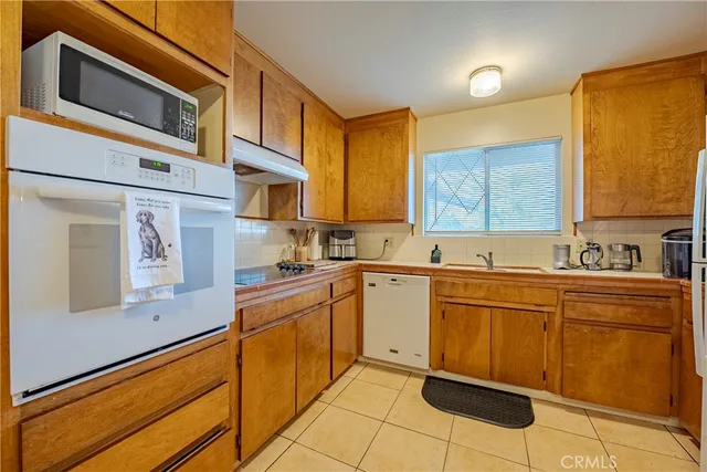 a kitchen with stainless steel appliances granite countertop a sink and cabinets