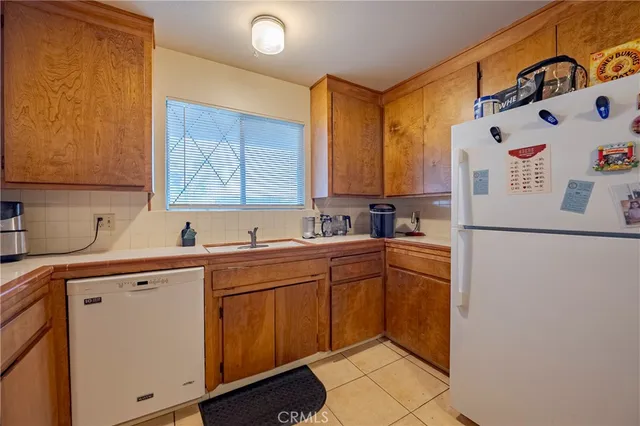 a kitchen with a sink a refrigerator and window