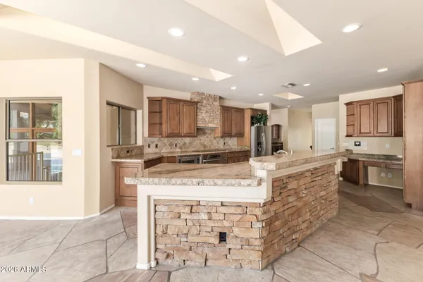 a bathroom with a granite countertop sink double and mirror
