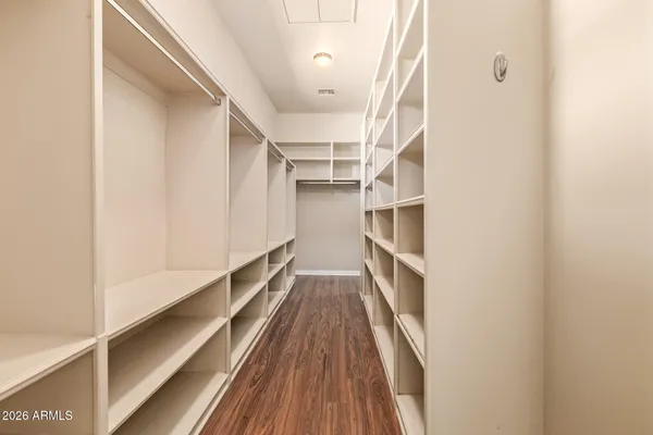 an empty room with closet and a ceiling fan