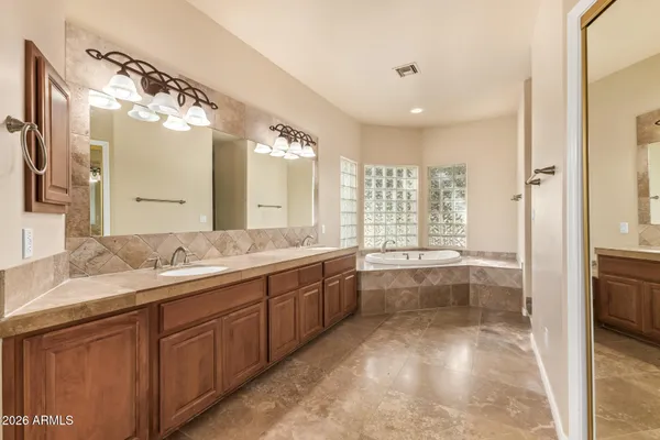 a utility room with granite countertop cabinets washer and dryer