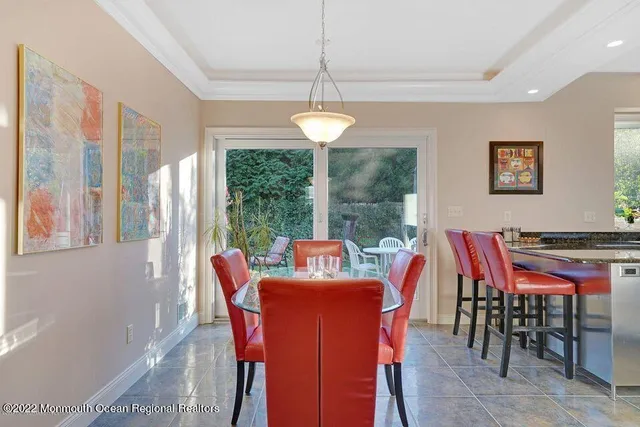 a dining room with furniture a chandelier and a rug