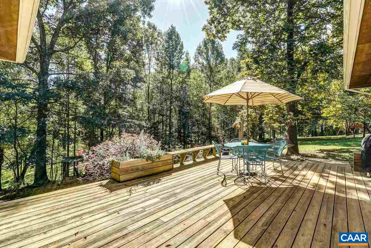 2227 Miller Lake Road Afton, VA 22920 - Photo 21 of 45 a view of a chair and tables on the deck