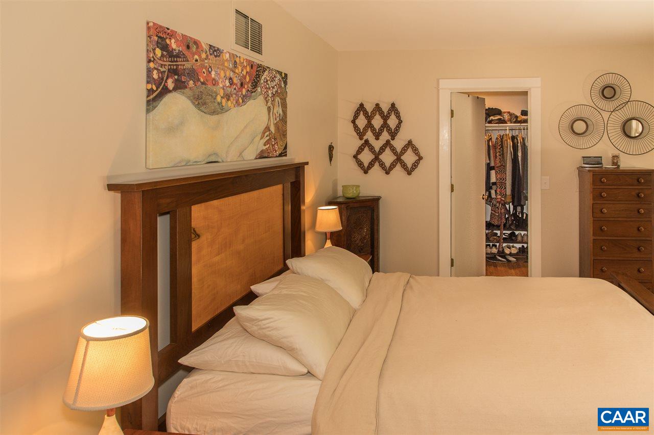 2227 Miller Lake Road Afton, VA 22920 - Photo 26 of 45 a bedroom with a bed and a painting on the wall