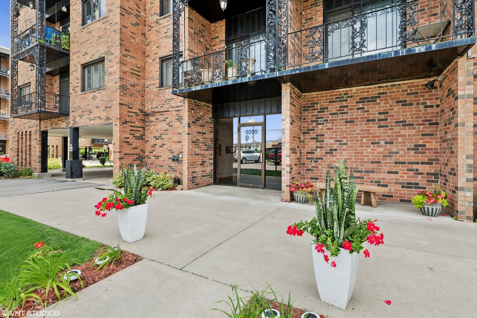 9355 Landings Lane, Unit 406 Des Plaines, IL 60016 - Photo 1 of 1 a flower garden in front of the building
