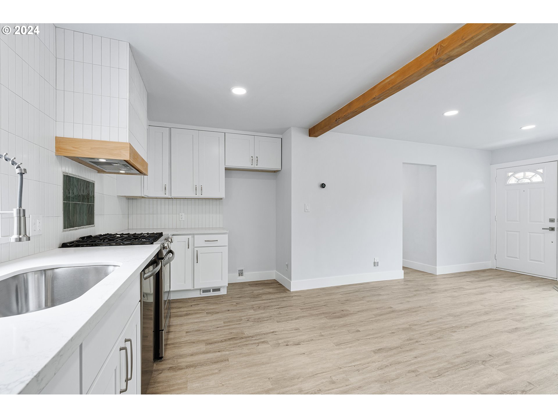 9045 Southeast Morrison Street Portland, OR 97216 - Photo 14 of 35 a kitchen with granite countertop a sink and a stove top oven