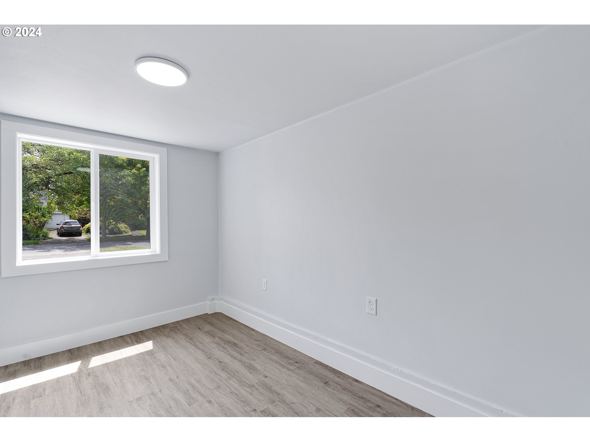 9045 Southeast Morrison Street Portland, OR 97216 - Photo 24 of 35 a view of an empty room with wooden floor and a window