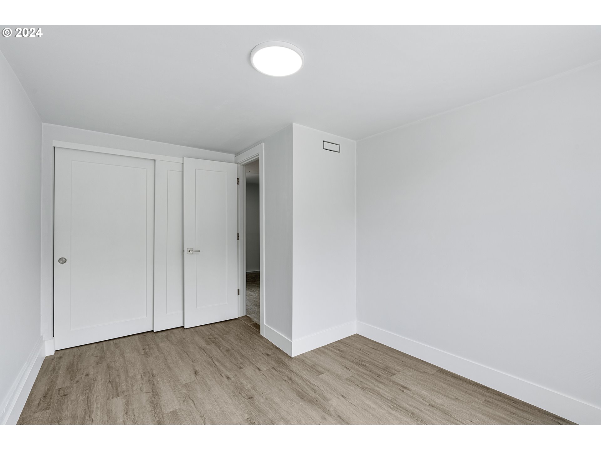 9045 Southeast Morrison Street Portland, OR 97216 - Photo 26 of 35 a view of an empty room and wooden floor