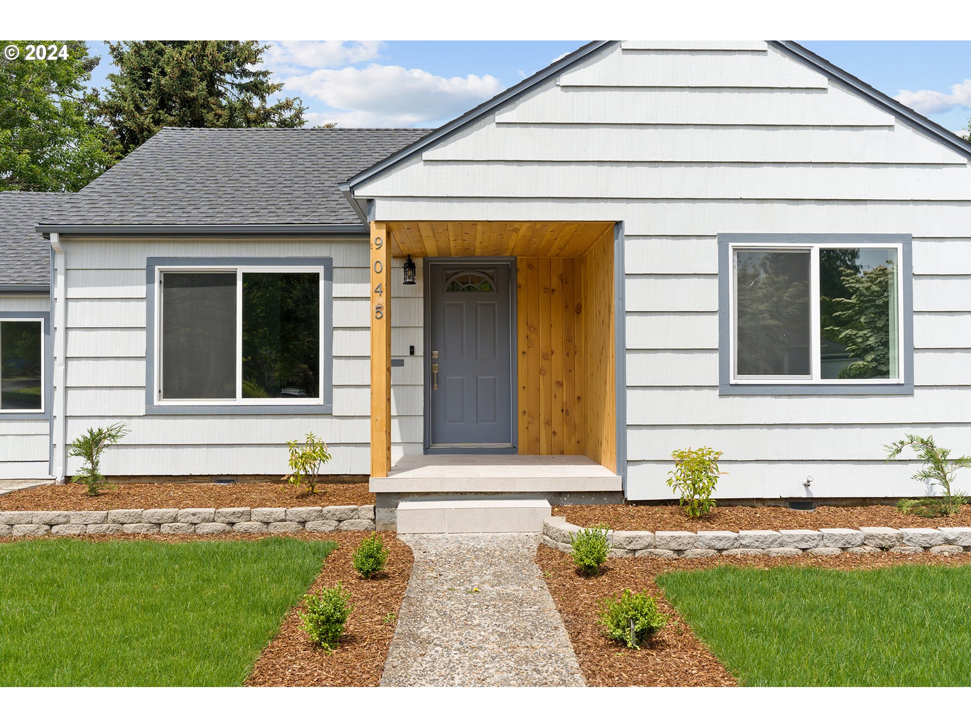 9045 Southeast Morrison Street Portland, OR 97216 - Photo 4 of 35 a front view of a house with a yard