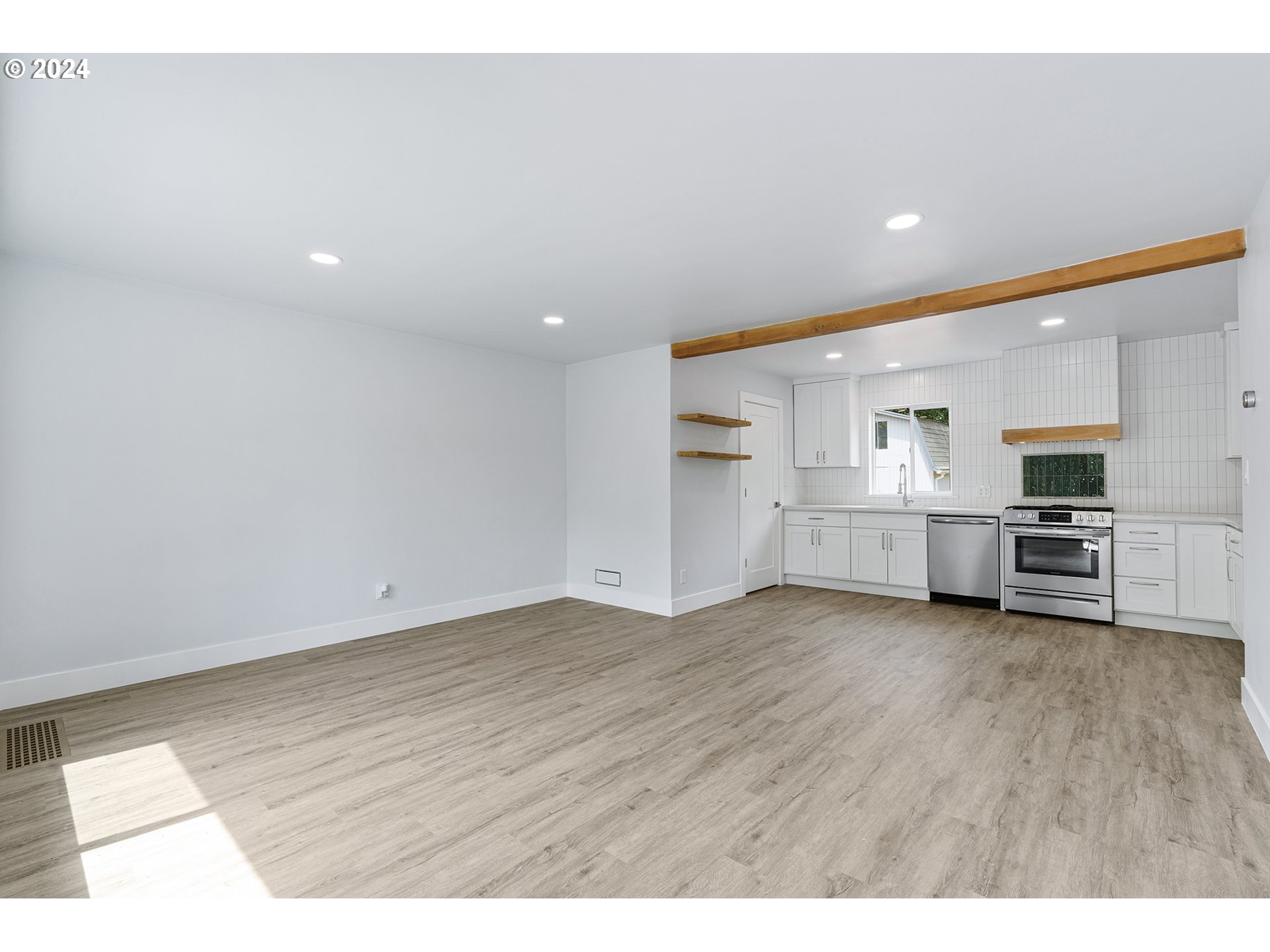 9045 Southeast Morrison Street Portland, OR 97216 - Photo 5 of 35 a view of empty room with wooden floor