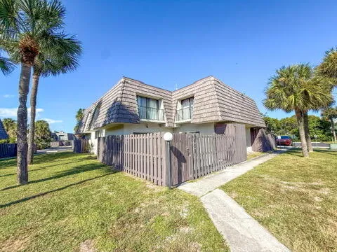 a front view of a house with a garden and yard