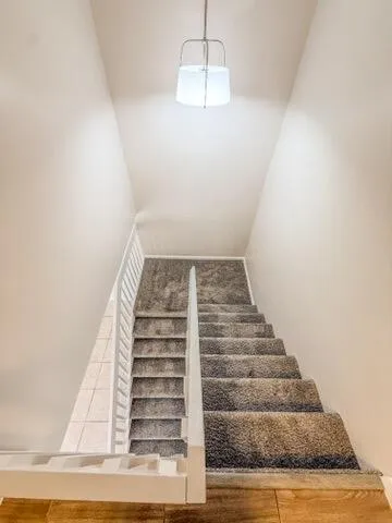 a view of a room with wooden floor and fan