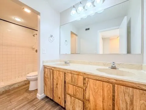 a white toilet next to a bathroom