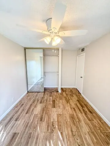 a bathroom with a granite countertop sink a toilet and bathtub