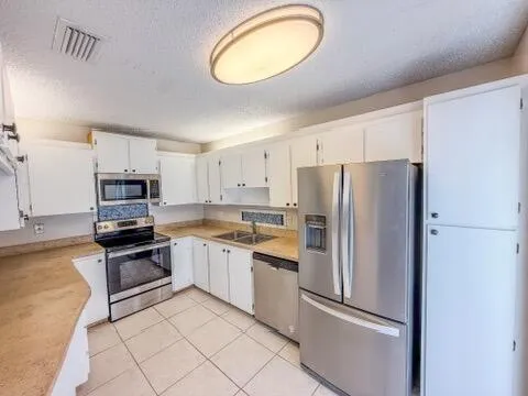 a kitchen with stainless steel appliances a stove sink and cabinets
