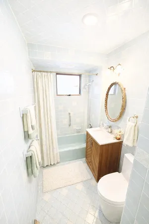 a bathroom with a sink mirror vanity and toilet