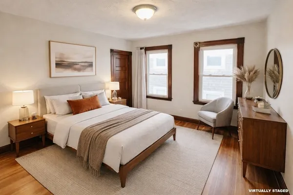 a bedroom with a large bed and windows