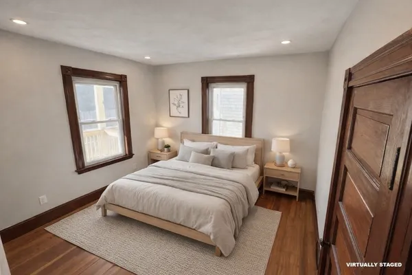 a bedroom with a bed and a large mirror