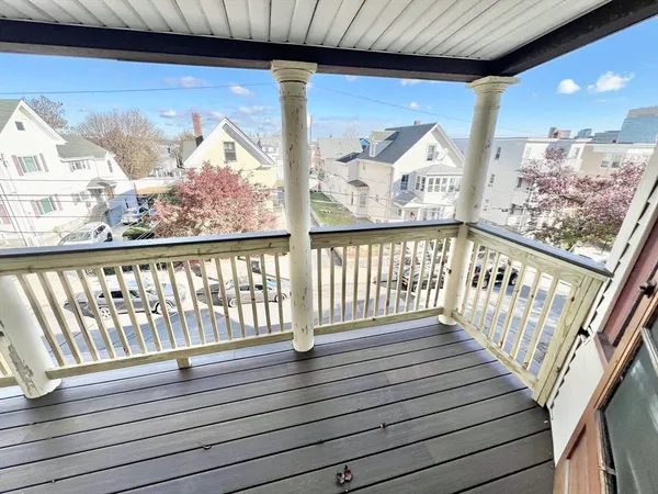 a view of wooden balcony with furniture