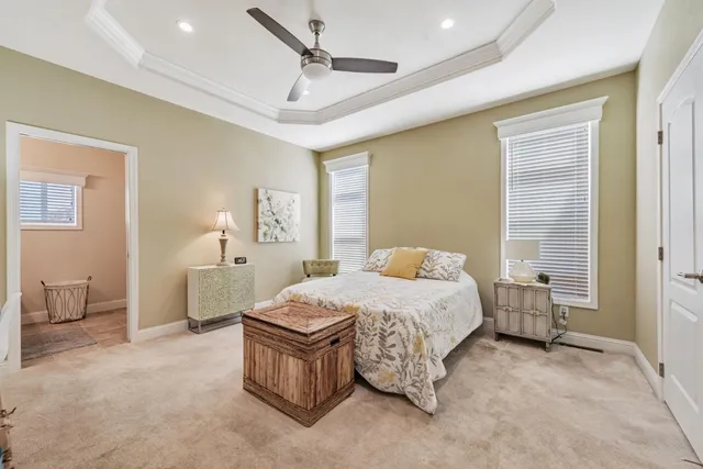 a spacious bedroom with a bed a chandelier and closet