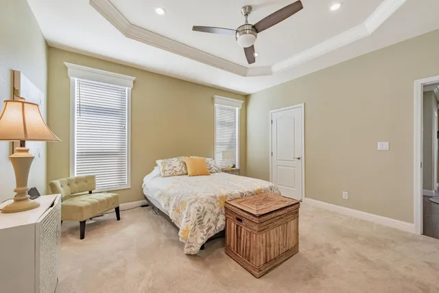 a spacious bedroom with a bed and a table