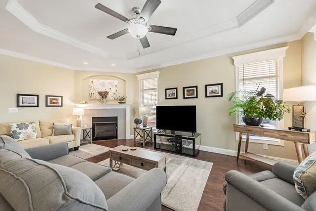 a living room with furniture a fireplace and a flat screen tv