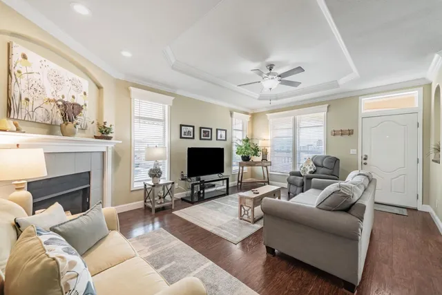 a living room with furniture a fireplace and a flat screen tv