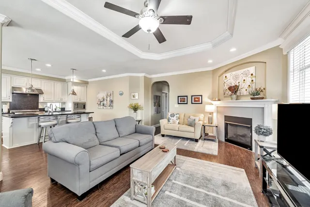 a living room with furniture a fireplace and a flat screen tv