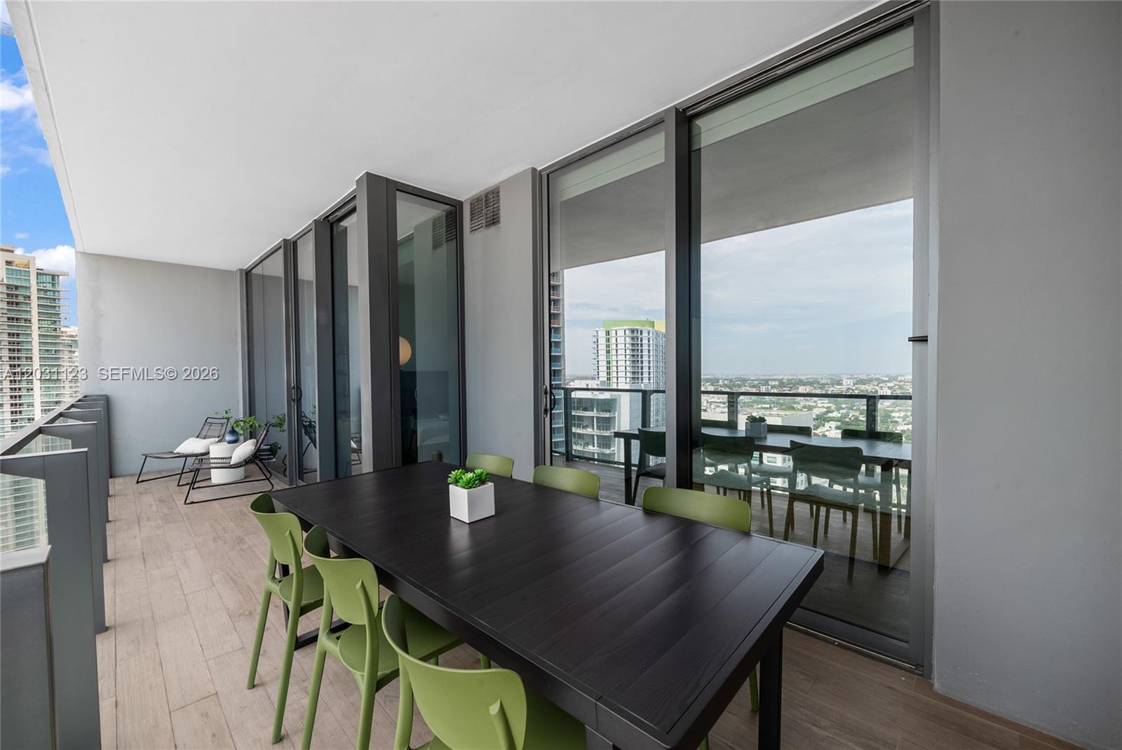 88 Southwest 7th Street, Unit 3208 Miami, FL 33130 - Photo 11 of 16 a view of a dining room with furniture window and wooden floor