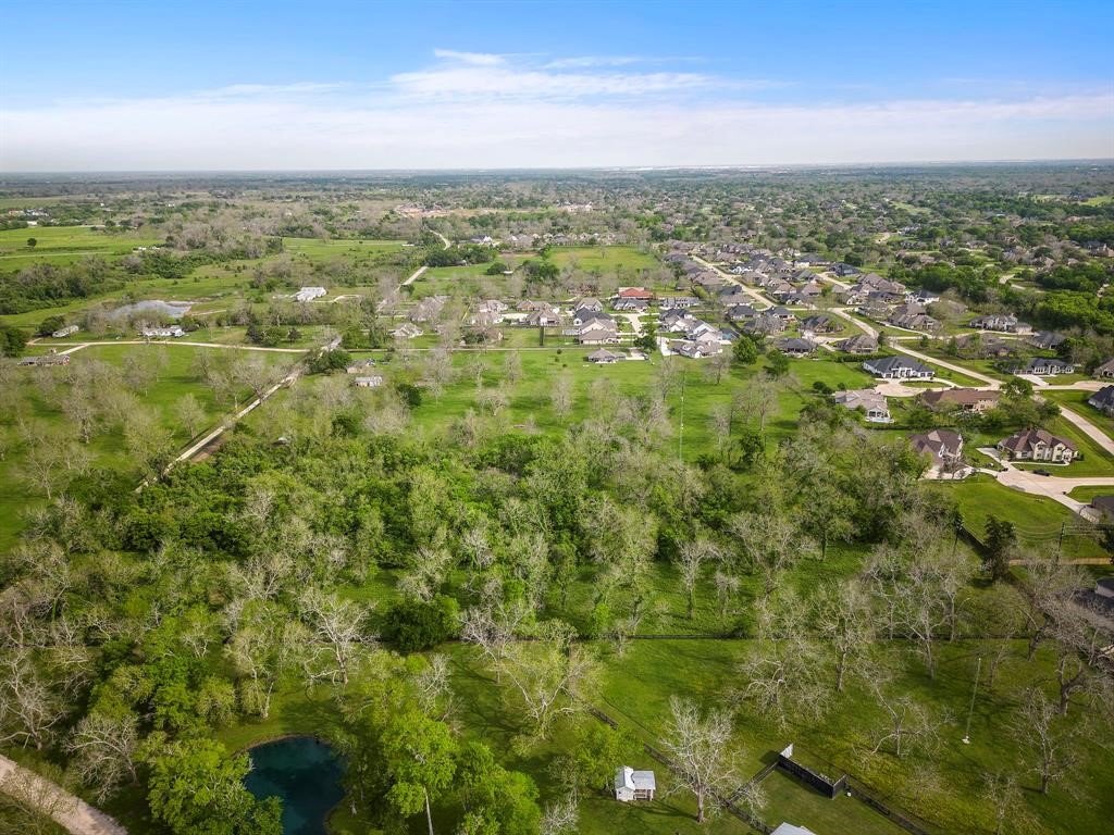 2990 Bowser Road Fulshear, TX 77441 - Photo 9 of 9 an aerial view of residential houses with outdoor space and trees