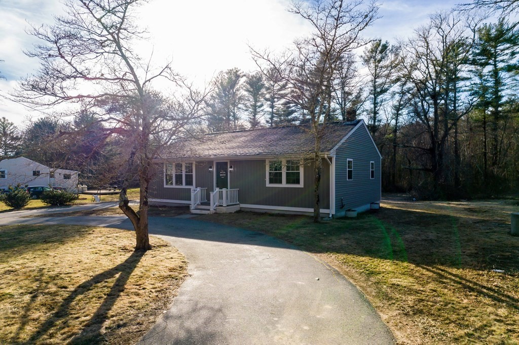 213 Walnut Plain Road Rochester, MA 02770 - Photo 1 of 38 a front view of a house with garden