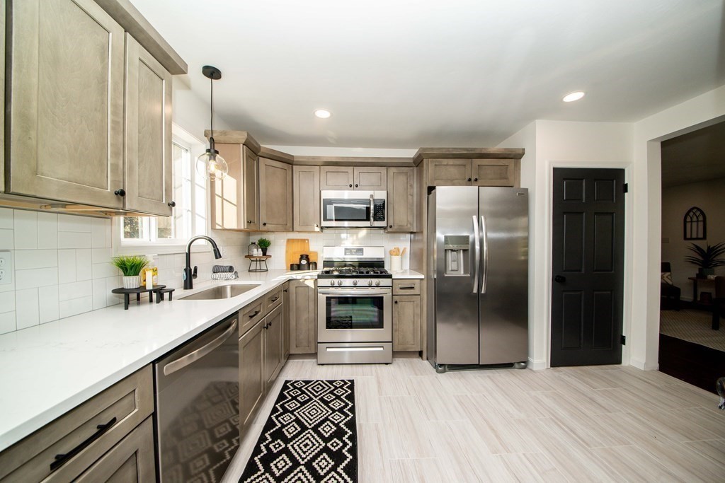 213 Walnut Plain Road Rochester, MA 02770 - Photo 13 of 38 a kitchen with stainless steel appliances granite countertop a refrigerator a sink a stove a microwave and island