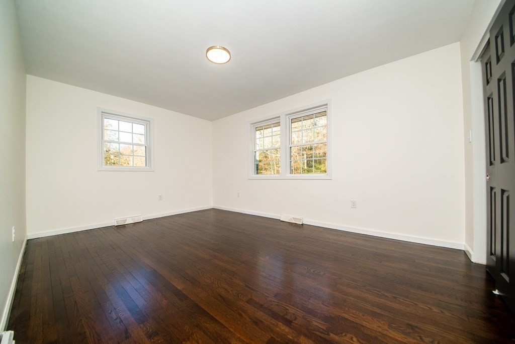213 Walnut Plain Road Rochester, MA 02770 - Photo 23 of 38 an empty room with wooden floor and windows