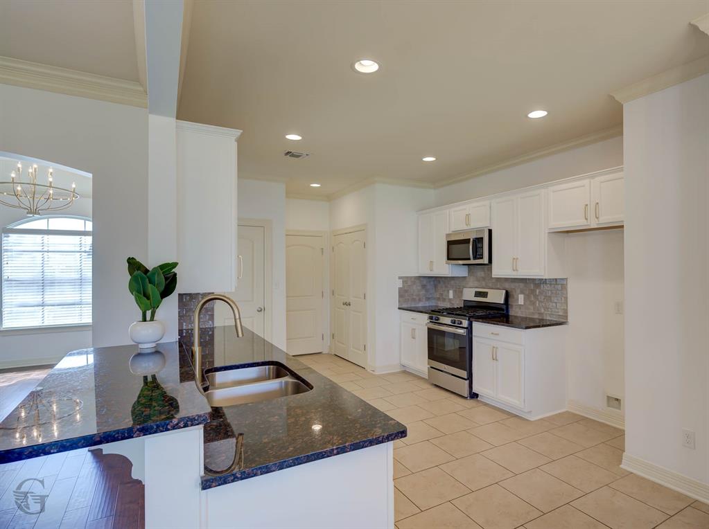 233 Sedgewick Avenue Haughton, LA 71037 - Photo 6 of 19 a kitchen with stainless steel appliances granite countertop a sink stove and refrigerator