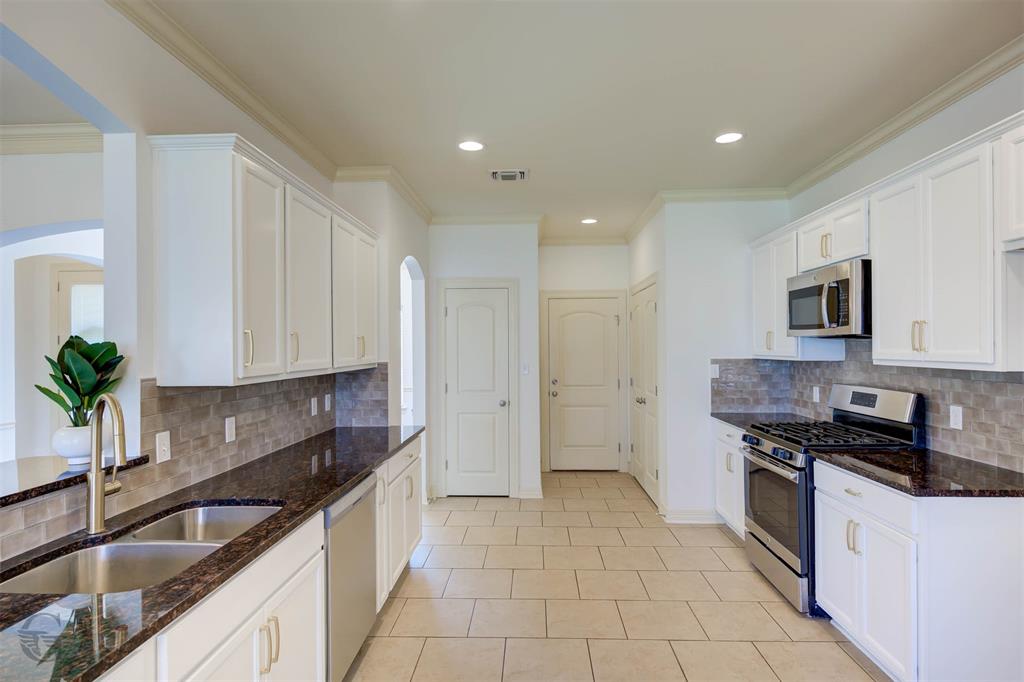 233 Sedgewick Avenue Haughton, LA 71037 - Photo 7 of 19 a kitchen with stainless steel appliances granite countertop a sink a stove and a refrigerator