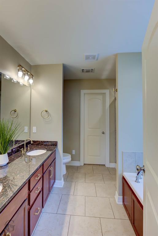 233 Sedgewick Avenue Haughton, LA 71037 - Photo 10 of 19 a spacious bathroom with a granite countertop sink a toilet and a mirror