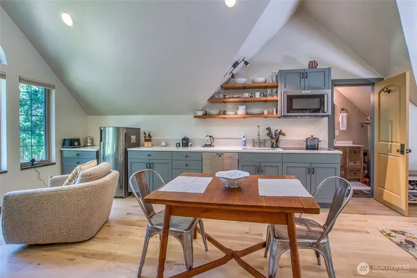 a dining room with furniture and wooden floor