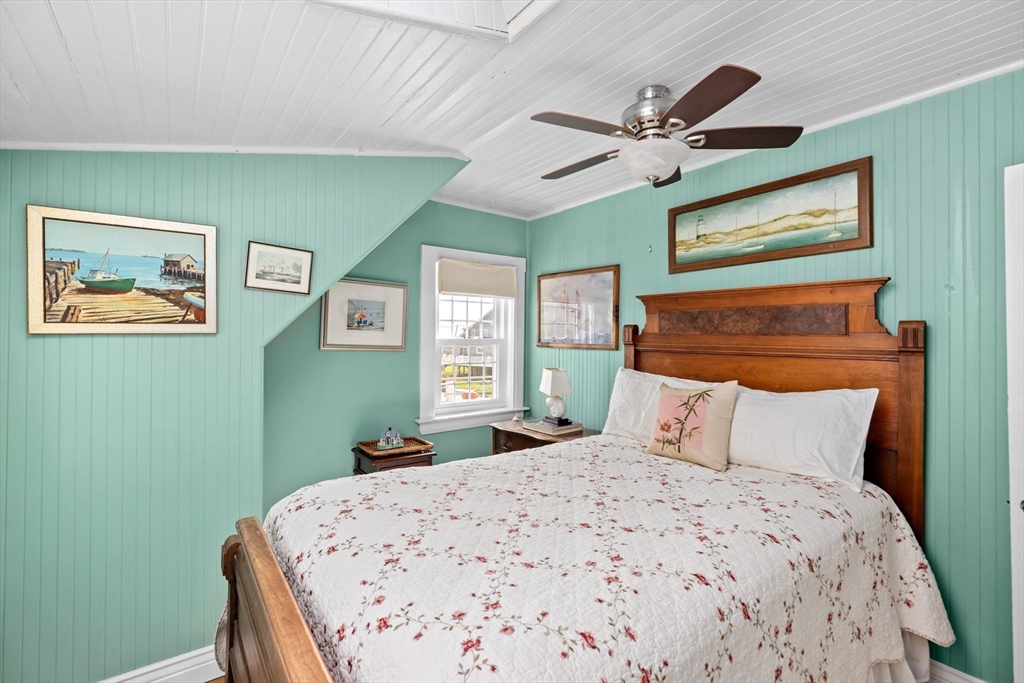 79 Kenneth Road Scituate, MA 02066 - Photo 24 of 39 a bedroom with a bed and a chandelier