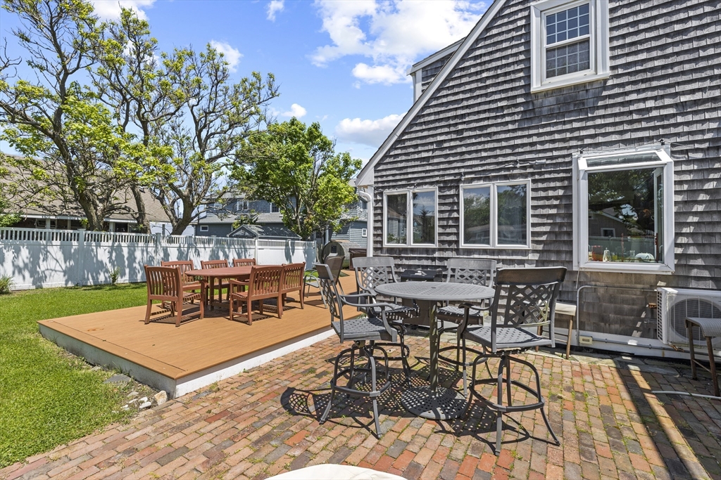 79 Kenneth Road Scituate, MA 02066 - Photo 33 of 39 a view of a patio with table and chairs with wooden floor and fence